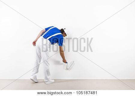 Painter With Paintroller On White Wall