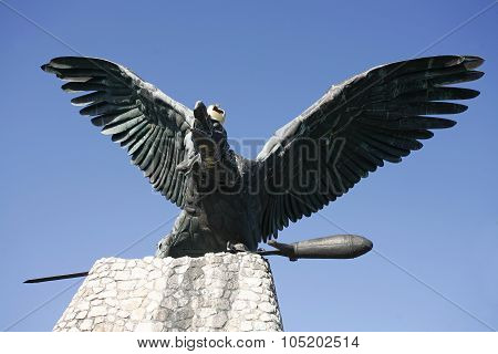Statue Of The Famous Hungarian Legendary Turul Bird Against Blue Sky