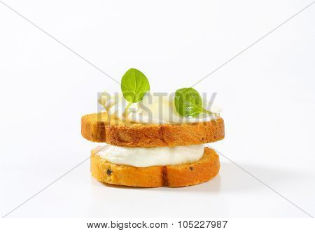 bread rusks with cream cheese on white background