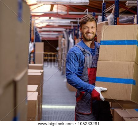 Porter carrying boxes in a warehouse 