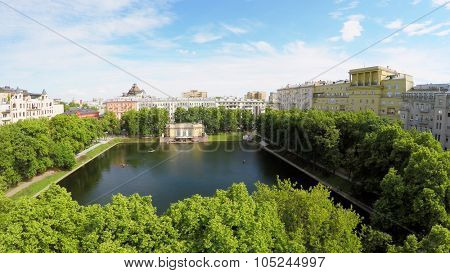 Park with Patriarshy pond among residential houses at summer sunny day. Aerial view videoframe