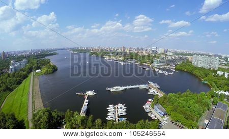 Cityscape with many yachts on moorage in city river bay at summer sunny day. Aerial view videoframe