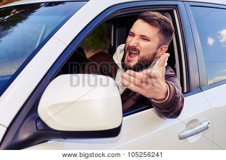 discontented young man shouting from the window of his car