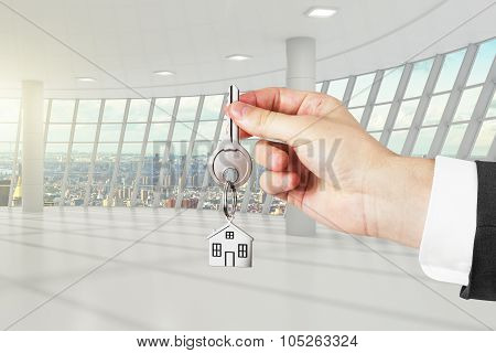 Hand With Key From A New White Loft