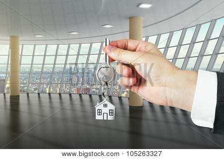 Hand With Key From A New Big Loft