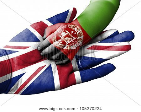 Adult Man Holding A Baby Hand With United Kingdom And Afghanistan Flags Overlaid. Isolated On White