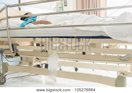 Clear Plastic Urine Bag Hang On Bed Of Female Patient