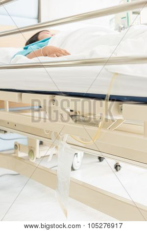 Clear Plastic Urine Bag Hang On Bed Of Female Patient