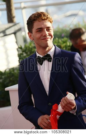 CANNES, FRANCE - MAY 24: Xavier Dolan winner of the Best Director award, attends the Palme D'Or Winners photocall during the 67th Cannes Film Festival on May 24, 2014 in Cannes, France.