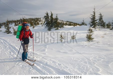Woman cross country skiing in the mountain