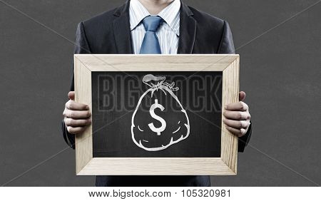 Unrecognizable businessman holding blackboard with drawn dollar concept