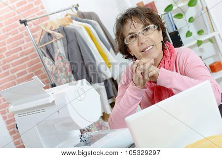 Portrait of happy dressmaker woman in studio