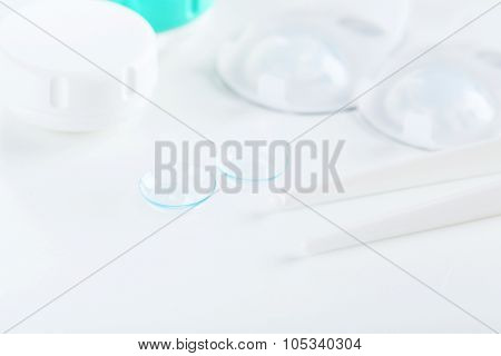 Contact Lenses In Container With Solution On White Background