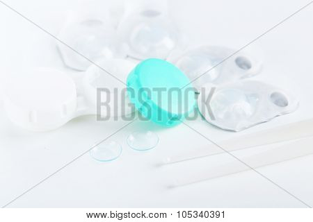 Contact Lenses In Container With Solution On White Background