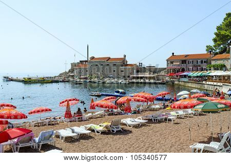 Beach In Resort Town Of Petrovac In Background Of Old Venetian Fortress, Montenegro