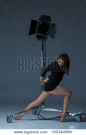 The Beautiful Ballerina Posing On Dack Blue Background