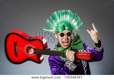 Funny man playing guitar in musical concept