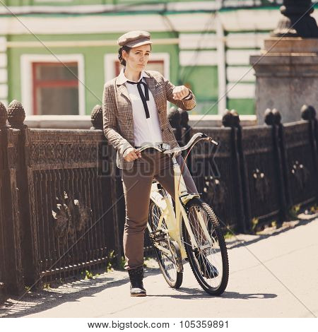 Young Woman At Vintage Bicycle British Style