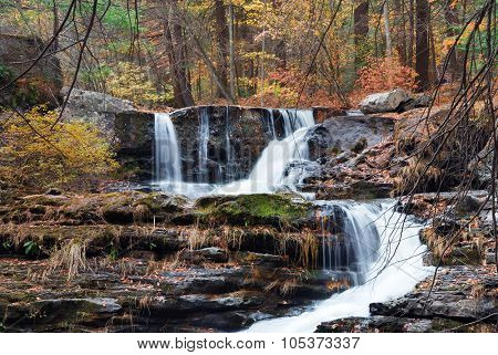 Waterfall with trees and rocks in mountain in Autumn. From Pennsylvania Dingmans Falls.