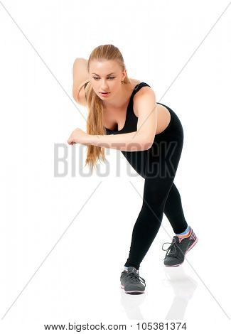 Young sportswoman doing stretching exorcises on a white background