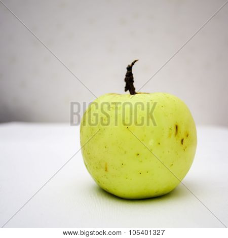 Yellow ripe apple on the table