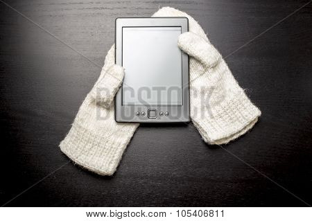 E-book lying on the white gloves, as if lying in the hands of a man