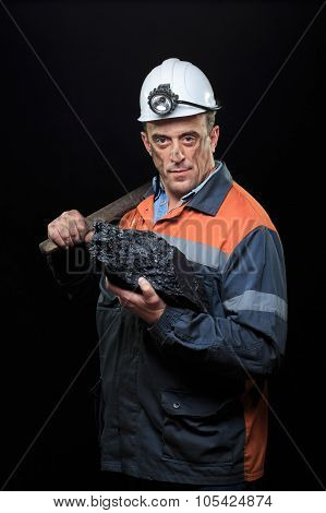 coalminer holds out a large chunk of energy rich coal