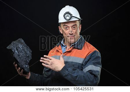 coalminer holds out a large chunk of energy rich coal