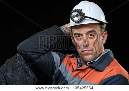 coalminer holds out a large chunk of energy rich coal