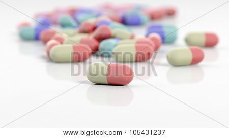 Colorful caplets with depth of field, on white background.