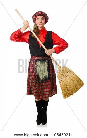 Funny woman in scottish clothing with broom