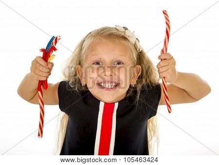 Beautiful Little Female Child With Blue Eyes Eating Strawberry Licorice Candy