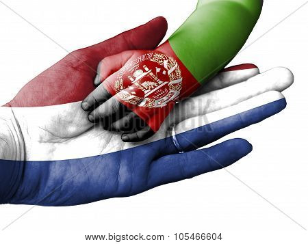Adult Man Holding A Baby Hand With Netherlands And Afghanistan Flags Overlaid. Isolated On White