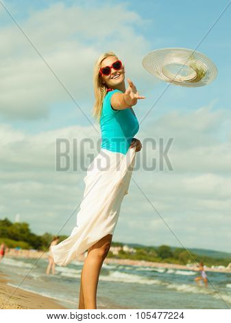 Girl Trowing Hat Up On Beach