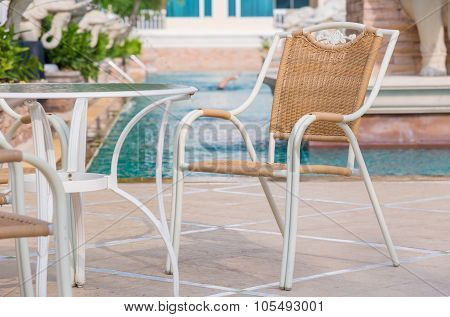 Chairs And Tables Next To Swimming Pool