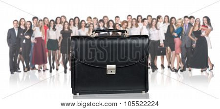 Black briefcase foreground and business peole