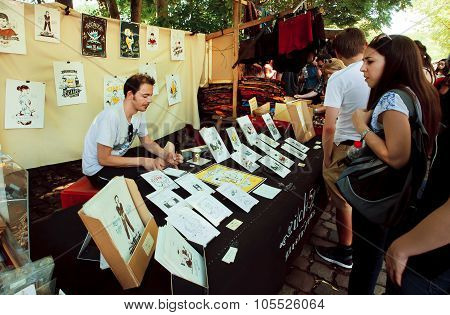 Young artist draws and sells graphic arts outdoor