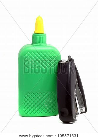 Bottle Of Glue And Old Stapler On A White Background