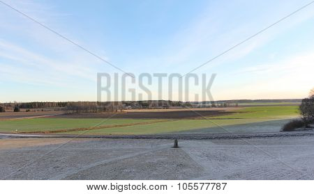 The big stones standing in the snow field in winter