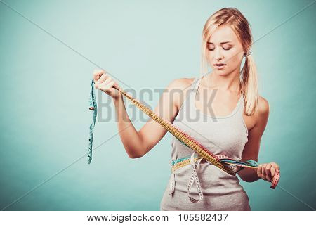 Fitness Girl Measuring Her Body With Tapes