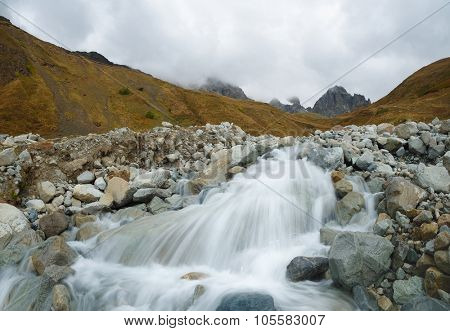 Landscape with a mountain river. Cloudy day. Valley under a mountain of Ushba. Main Caucasian ridge. Zemo Svaneti, Georgia 