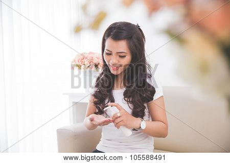 Woman Applying Lotion Into Her Skin