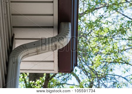 Gray Downspout Pipe Leading Down From Eavestrough
