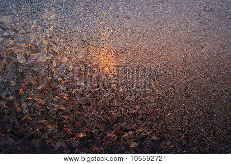 The Sun Is Shining Through The Frosted Glass. Frosty Pattern On The Frozen Stained Glass