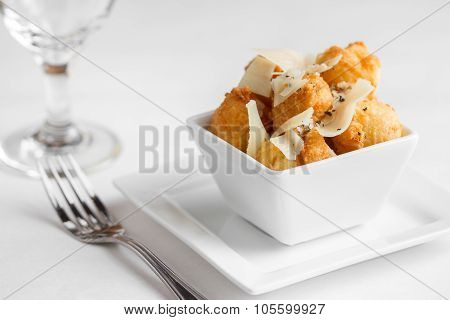 Fried cheese puffs with cracked black pepper