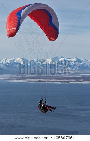 Paraglider Flying On Background Of Mountain And Sea