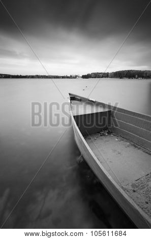 Lake Shore With Moored Boat. Long Exposure