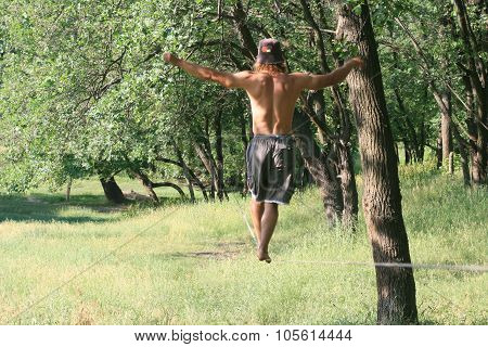 Man Walking On Slackline