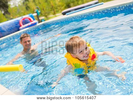 Child playing in swimming pool