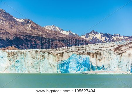 Massive glacier descends into the water.  The picturesque  shore of Lake Viedma. In the water ice-floes, broken away from a glacier